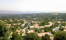 aerial view of houses with mountains in the background